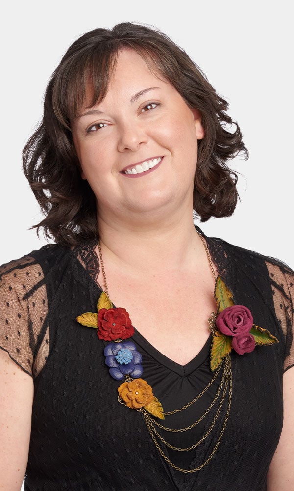 Model showing necklace made with scrap leather into flowers